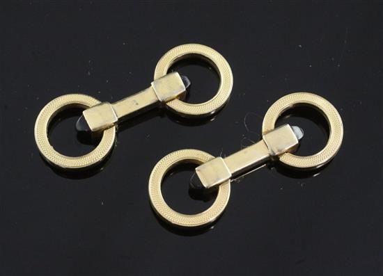 A pair of engine turned silver gilt and onyx double ring cufflinks, 1.5in.